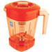 The Waring Raptor blender jar with an orange lid and handle.