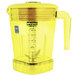 A yellow Waring blender jar with a handle.