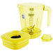 A yellow Waring blender jar with a lid.