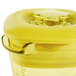 A yellow Waring blender jar with a yellow lid.