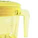 A yellow Waring blender jar with a handle and lid.