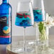 Two glasses of DaVinci Gourmet Classic Blue Curacao flavoring syrup with blue liquid and fruit in it.