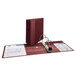 A maroon Avery Heavy-Duty binder with white paper inside.