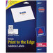 A package of Avery white print-to-the-edge address labels with a blue and yellow label on a blue box.