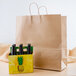 Jumbo 18" x 7" x 18 1/2" Natural Kraft Shopping Bag with Handles - 200/Bundle Main Thumbnail 1