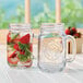 Two Libbey County Fair mason jars with strawberries and mint.