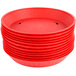 A stack of red plastic round platters with a white circle in the center.