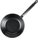 A black Town carbon steel frying pan with a handle.