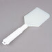 A Carlisle white plastic paddle with a white polyethylene blade and white polypropylene handle.