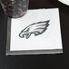 A Creative Converting Philadelphia Eagles beverage napkin with a logo on it.