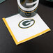 A green and white Creative Converting Green Bay Packers beverage napkin with the team logo.