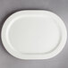 A Villeroy & Boch white porcelain oval plate on a gray surface.