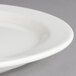 A close-up of a Villeroy & Boch white porcelain oval plate with a rim.