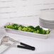 A Vollrath Miramar decorative steam table food pan with broccoli and tongs.