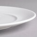 A close-up of a white Villeroy & Boch porcelain flat plate with a small rim.