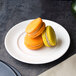 A Villeroy & Boch white porcelain flat plate with two macarons on it.