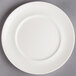 A white Villeroy & Boch porcelain plate with a circular edge on a gray surface.