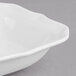 A close-up of a white Villeroy & Boch La Scala square bowl with a ruffled edge.