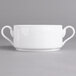 A close up of a Villeroy & Boch white porcelain soup cup with two curved handles.