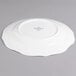 A white Villeroy & Boch porcelain flat plate with a small design on it.