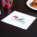 A red and white 2-ply luncheon napkin with a drawing of an Arizona Cardinals helmet on it next to a plate of chicken.