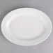 A white porcelain oval pickle dish.