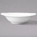 A Villeroy & Boch white porcelain oval bowl with a small rim on a gray surface.
