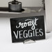 A stainless steel short single wave table card holder with a sign that says vegetables on it.