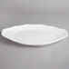 A white Villeroy & Boch porcelain oval plate with a scalloped edge.