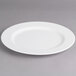 A white Villeroy & Boch porcelain flat plate with a rim on a gray surface.