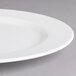 A close-up of a Villeroy & Boch white porcelain flat plate with a white rim.