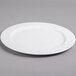 A white Villeroy & Boch porcelain round platter with a white rim on a gray surface.