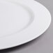 A close-up of a Villeroy & Boch white porcelain round platter with a white rim.
