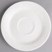 A white Villeroy & Boch porcelain saucer with a small rim on a gray surface.