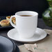 A white Villeroy & Boch Corpo saucer with a cup of coffee on it.