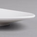 A close up of a Villeroy & Boch white porcelain oval plate.