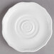 A close up of a Villeroy & Boch white porcelain saucer with a circular design.