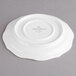 A white Villeroy & Boch porcelain saucer with a small design on it.