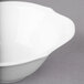A white Villeroy & Boch porcelain soup cup on a gray surface.