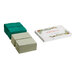 A white box with a red border containing stacks of green and white holiday placemats.