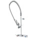 A chrome T&S EasyInstall wall mounted pre-rinse faucet with a flexible hose.