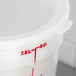 A white plastic lid for Cambro round food storage containers with red writing.