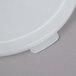 A white plastic lid with a small hole for a Cambro round food storage container.