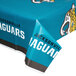 A blue plastic table cover with the Jacksonville Jaguars logo and a leopard print border.