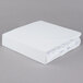 A white JT Eaton Twin XL bed bug box spring cover on a gray surface.