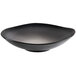 A black bowl with a curved edge and a white rim.