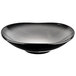 A black porcelain bowl with an obsidian finish and a white rim.