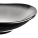 A close-up of a black and white bowl with a curved rim.