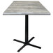 A Holland Bar Stool 30" square greystone table with a black cross base.