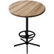 A round wooden Holland Bar Table with a black base.